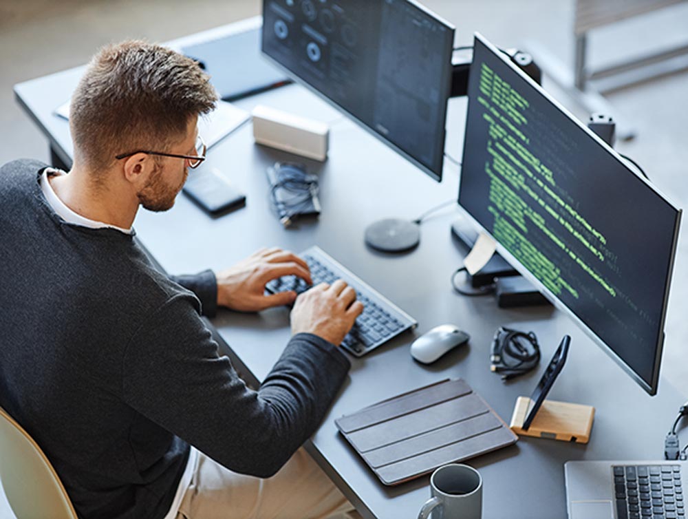 A software developer programming on a computer screen